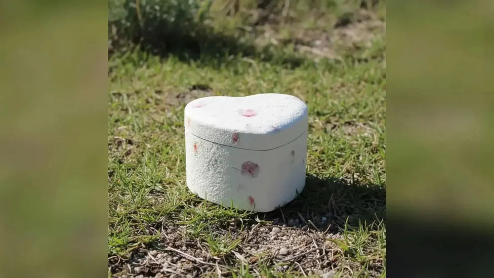 Small heart-shaped biodegradable urn outdoors