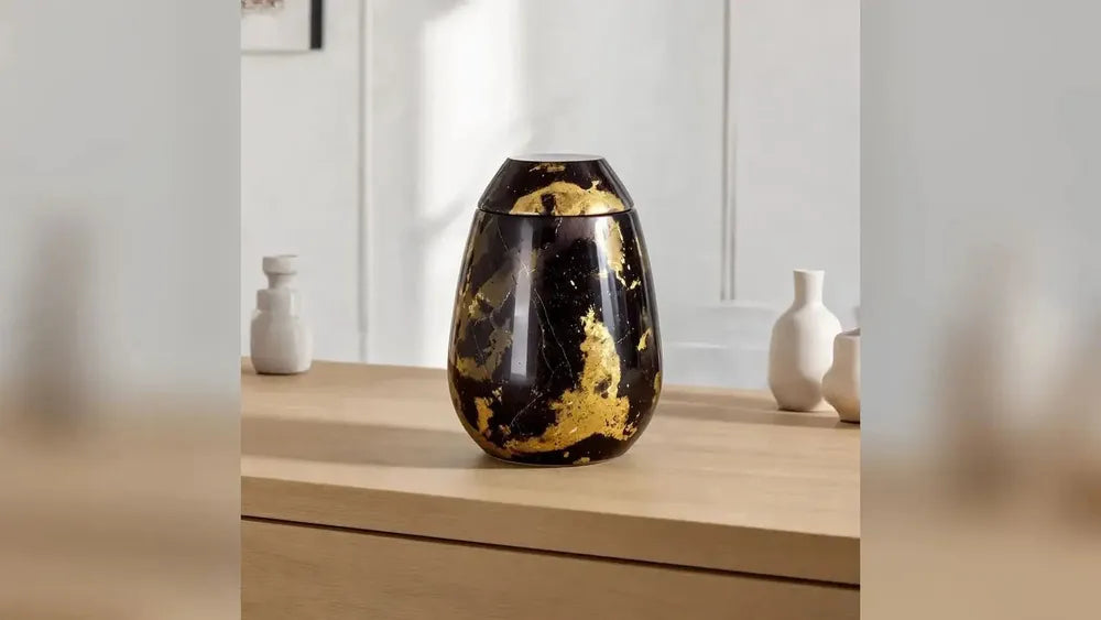 Marble adult cremation urn in brown and gold in a living room