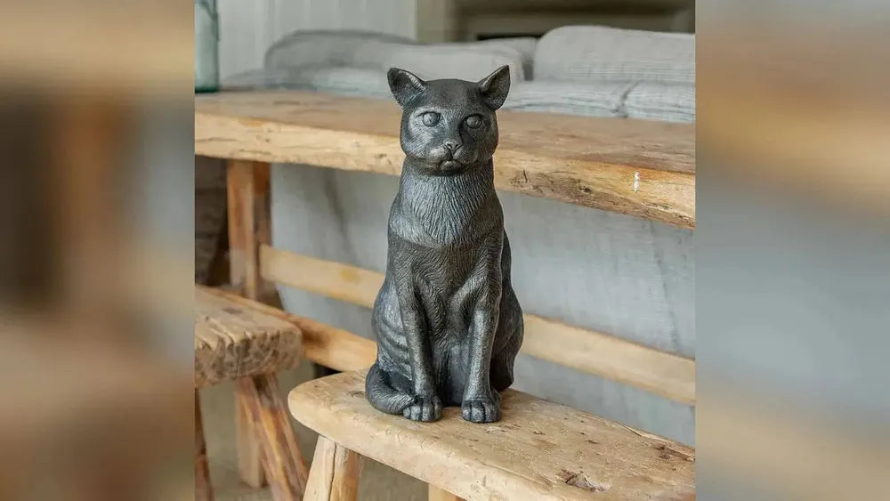 Sitting cat figurine urn for ashes on a bench