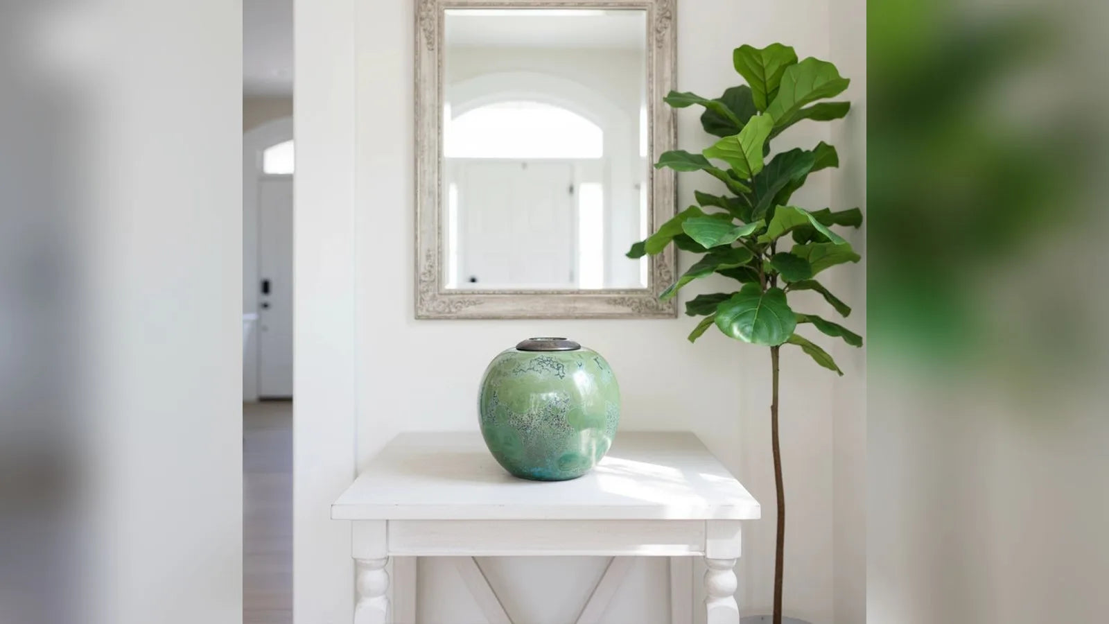 Jadeite adult cremation urn with a jade-green glaze on a hallway table
