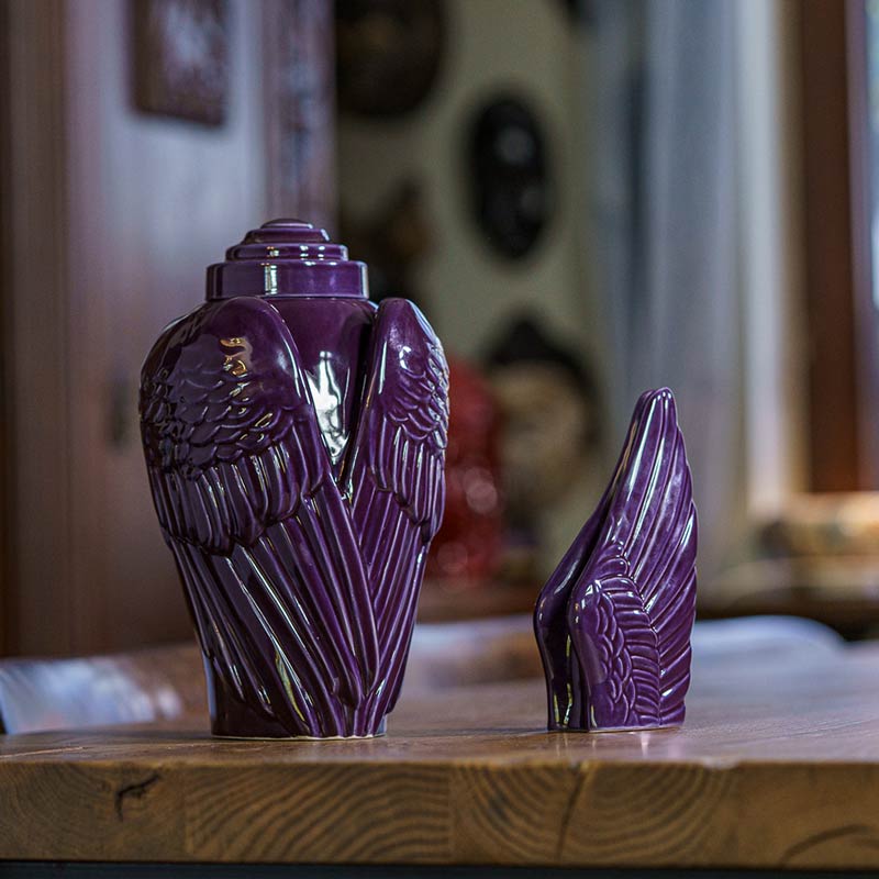 Angel Wings Small Urn for Ashes Violet with Adult Urn on Table