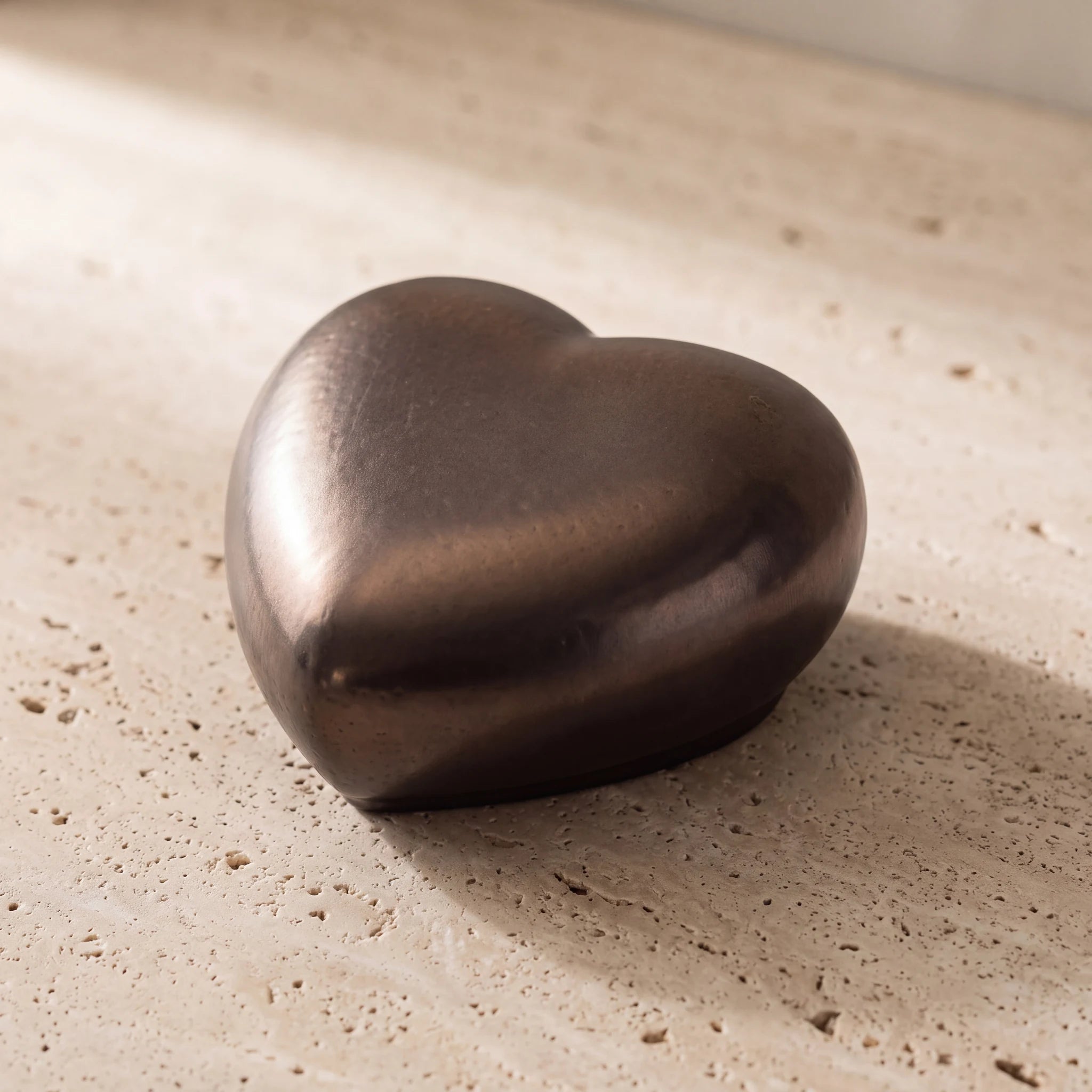 Big-Heart-Classic-Urn-for-Ashes-in-Antic-Gold-On-Travertine