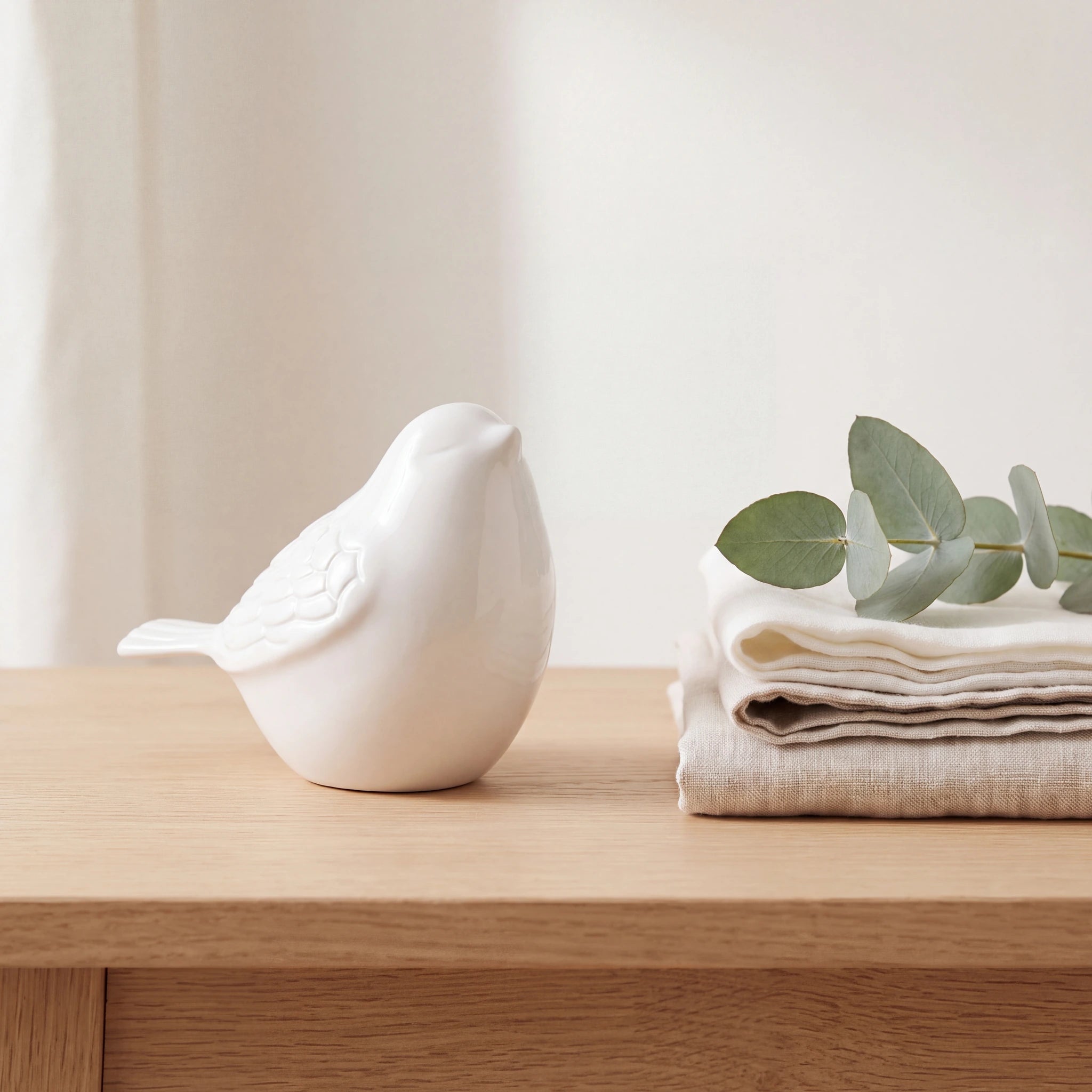 Bird-Keepsake-Urn-for-Ashes-in-White-Folded-Linen