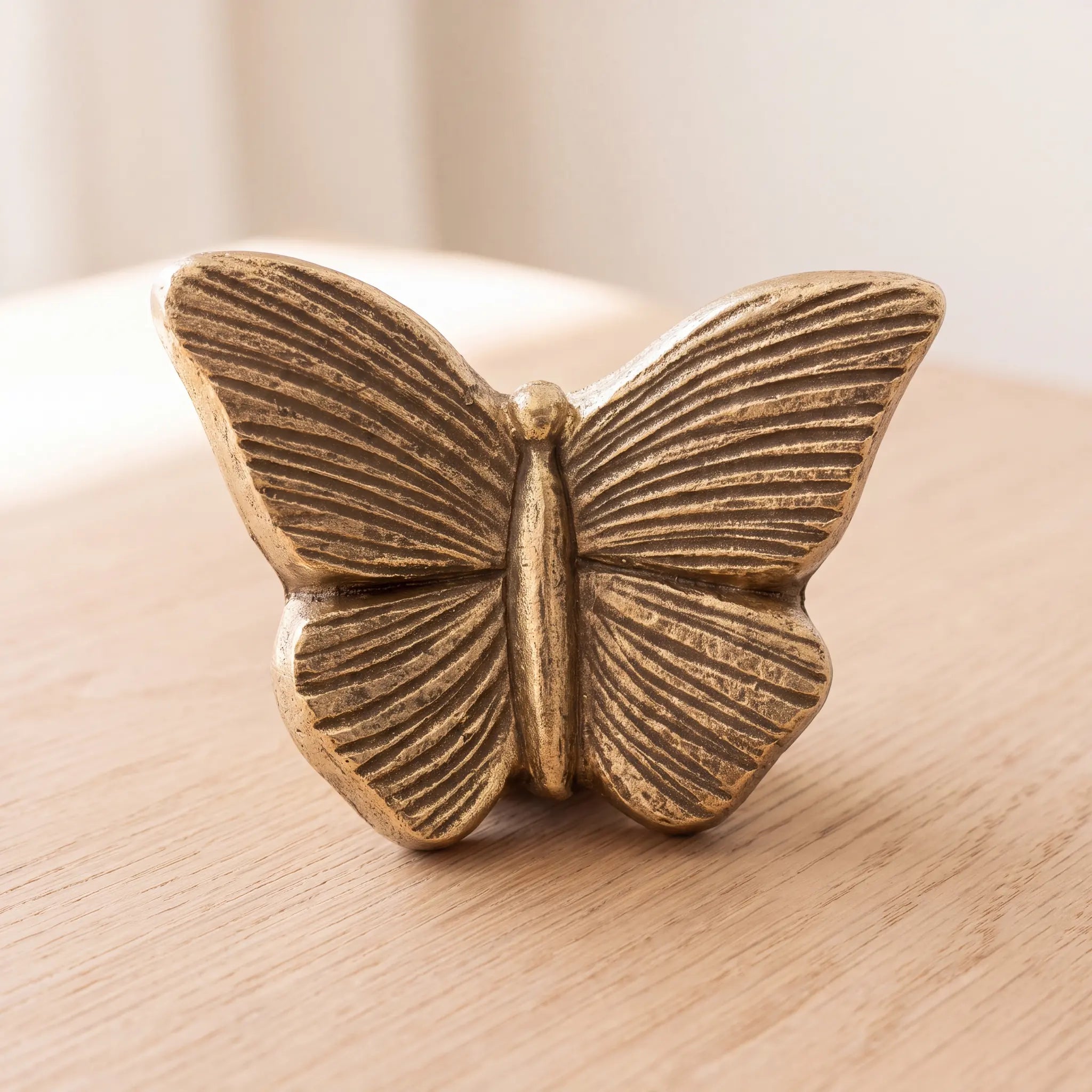 Butterfly-Keepsake-Urn-for-Ashes-in-Gold-On-Oak