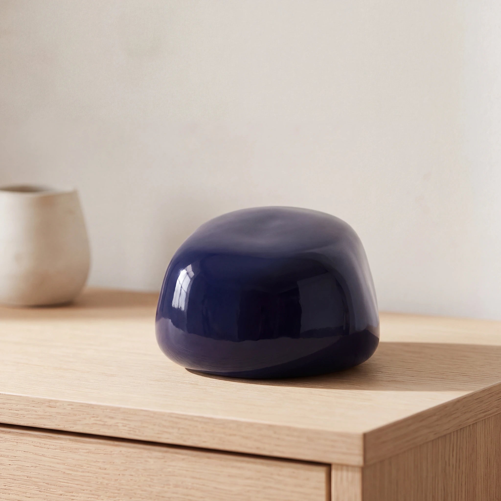Cuddle-Stone-Keepsake-Urn-for-Ashes-in-Dark-Blue-Oak-Console