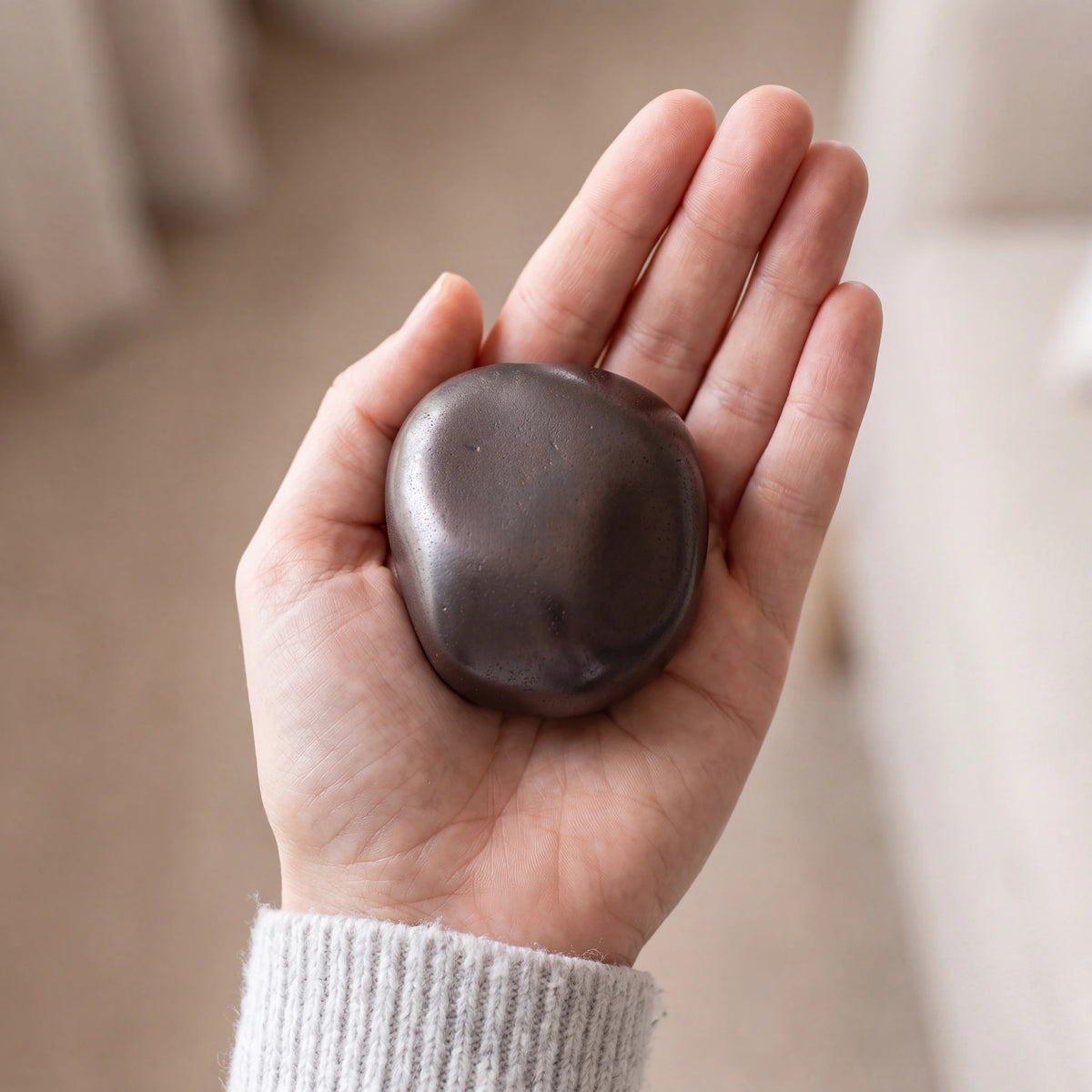 Cuddle-Stone-Keepsake-Urn-for-Ashes-in-Rustic-Bronze-Held-in-Palm