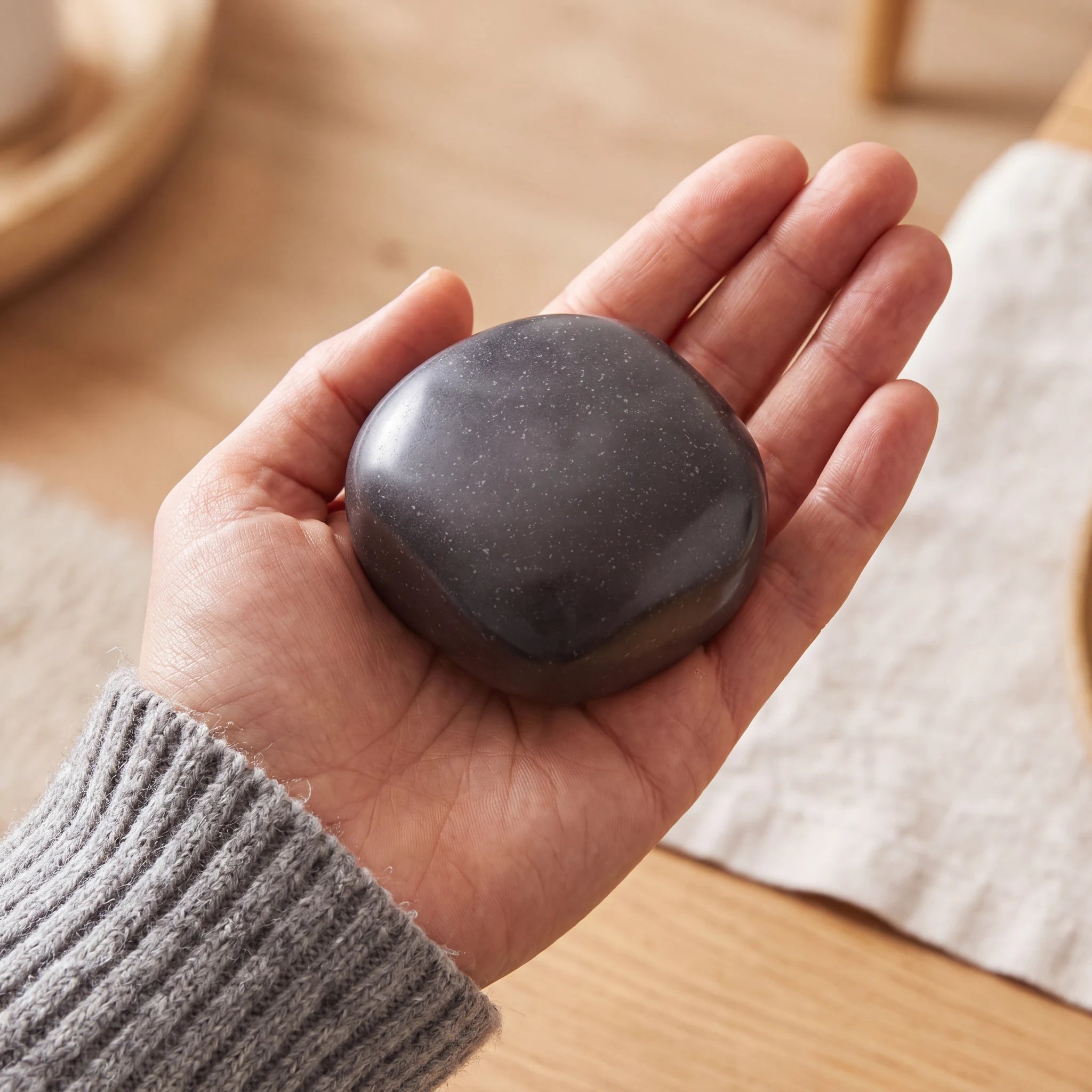 Cuddle-Stone-Keepsake-Urn-for-Ashes-in-Steel-Grey-Held-in-Palm
