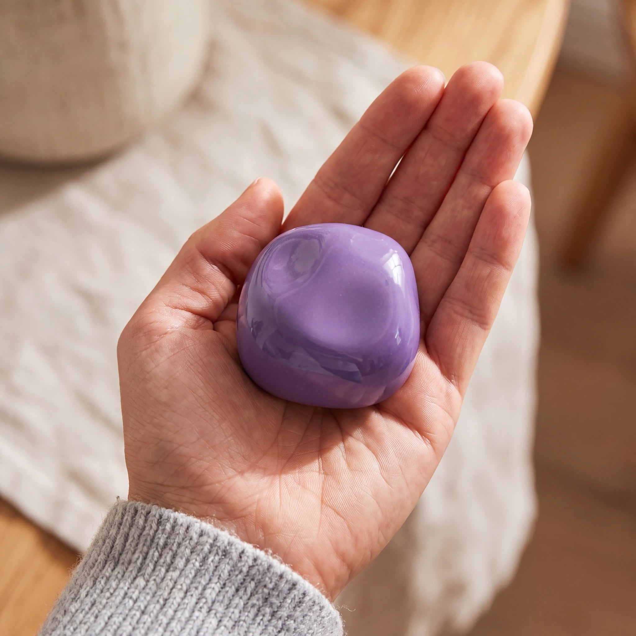 Cuddle-Stone-Keepsake-Urn-for-Ashes-in-Violet-Held-in-Palm