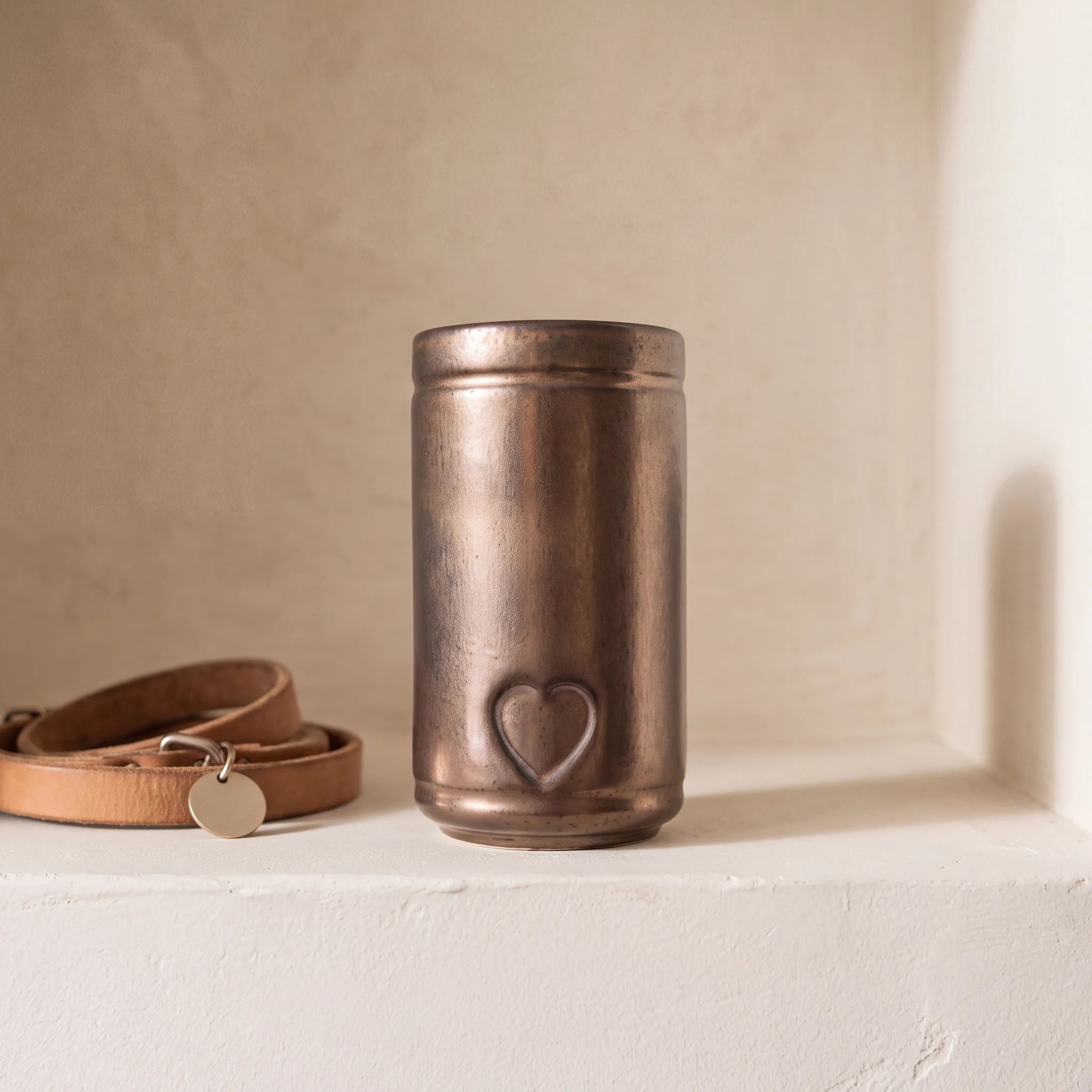 Cylinder-Pet-Urn-for-Ashes-in-Antic-Gold-pet_collar_ledge