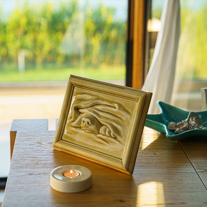 Dog Cremation Urn For Pets Ashes In Dark Sand With Candlelight