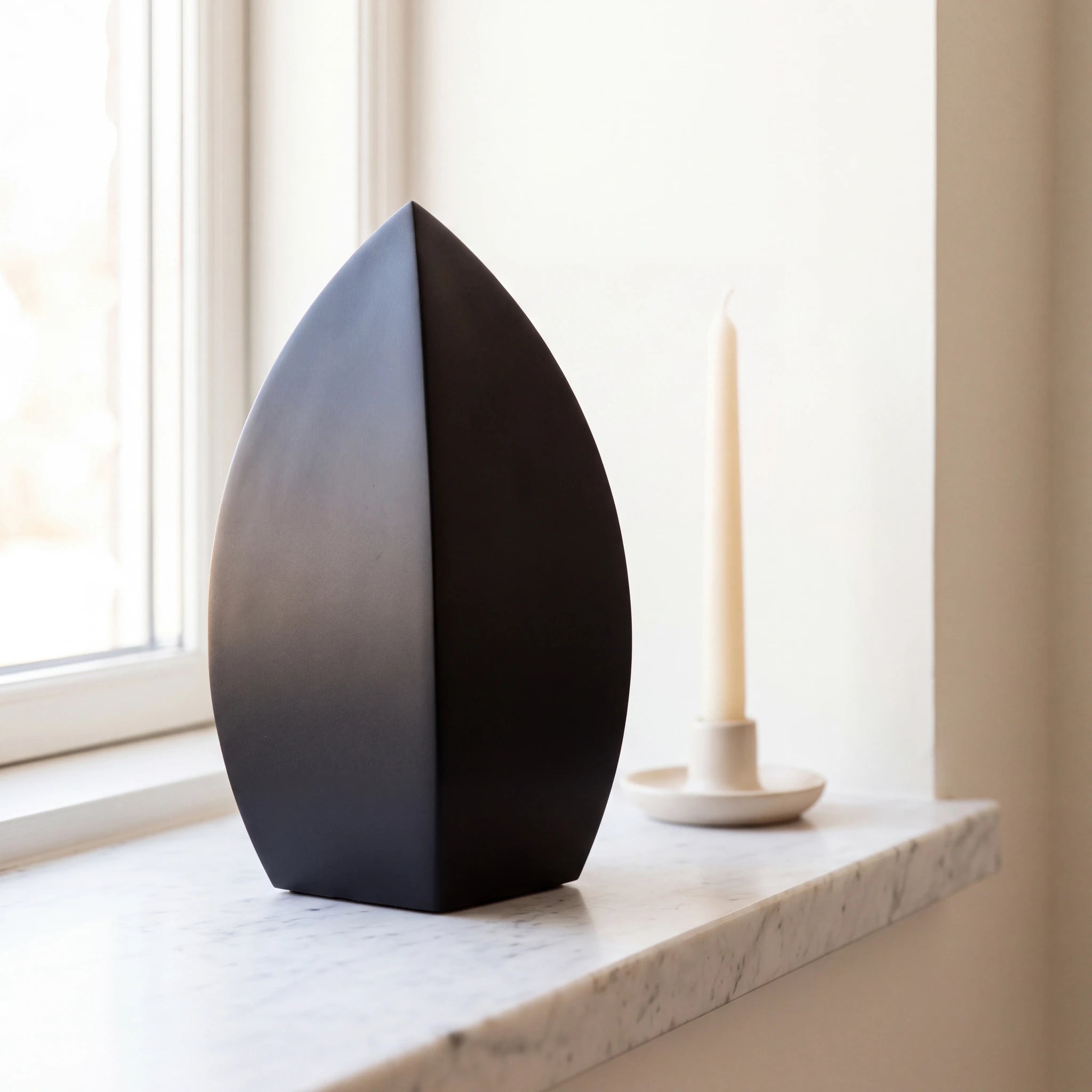 Drop-Small-Urn-for-Ashes-in-Matte-Black-Stainless-Steel-Marble-Ledge