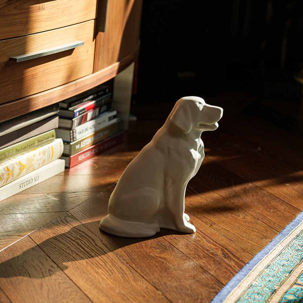 Golden Retriever Pet Urn for Ashes in Matte White on Floor Facing Right