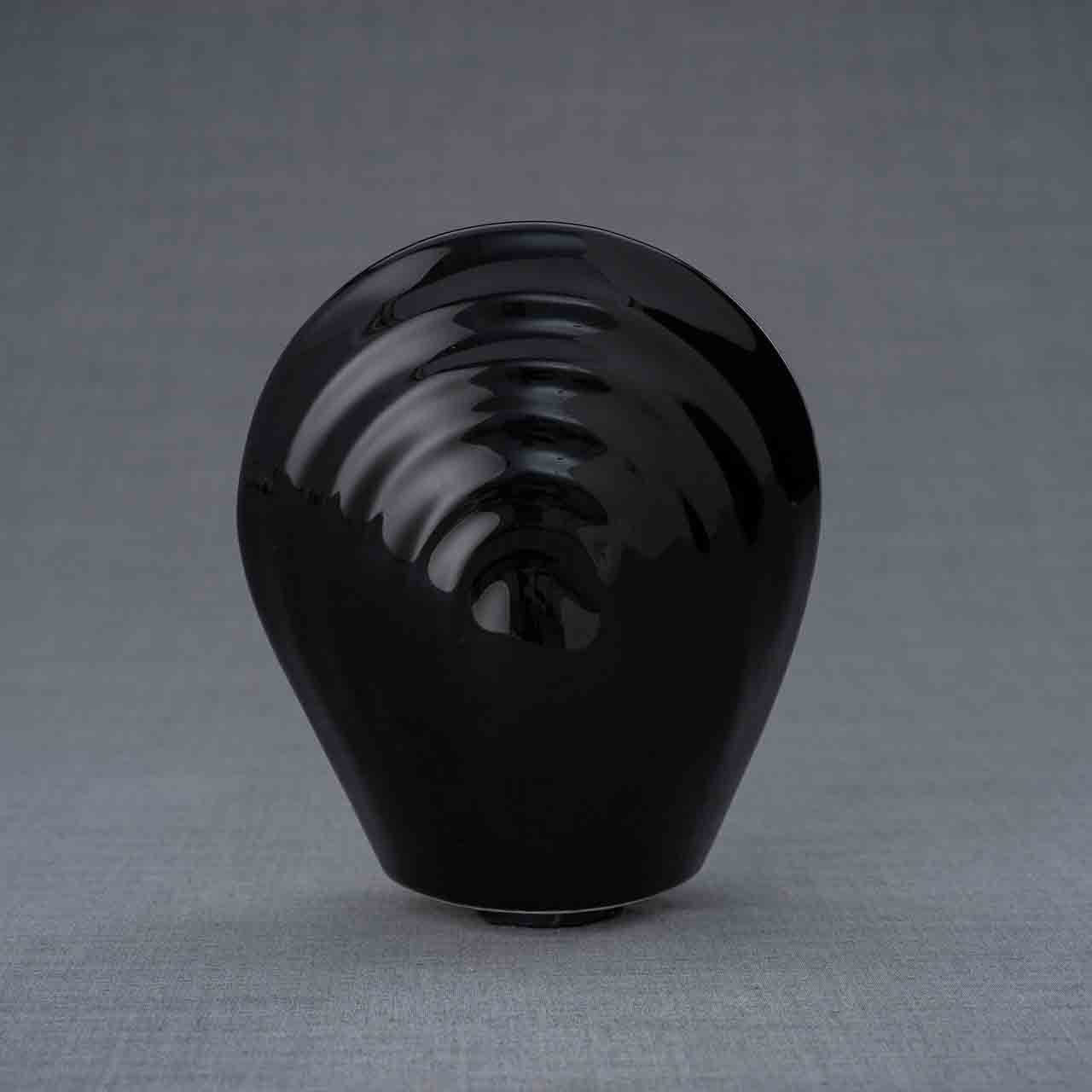 Guardian Angel Ashes Keepsake Urn in Black Behind Grey Background