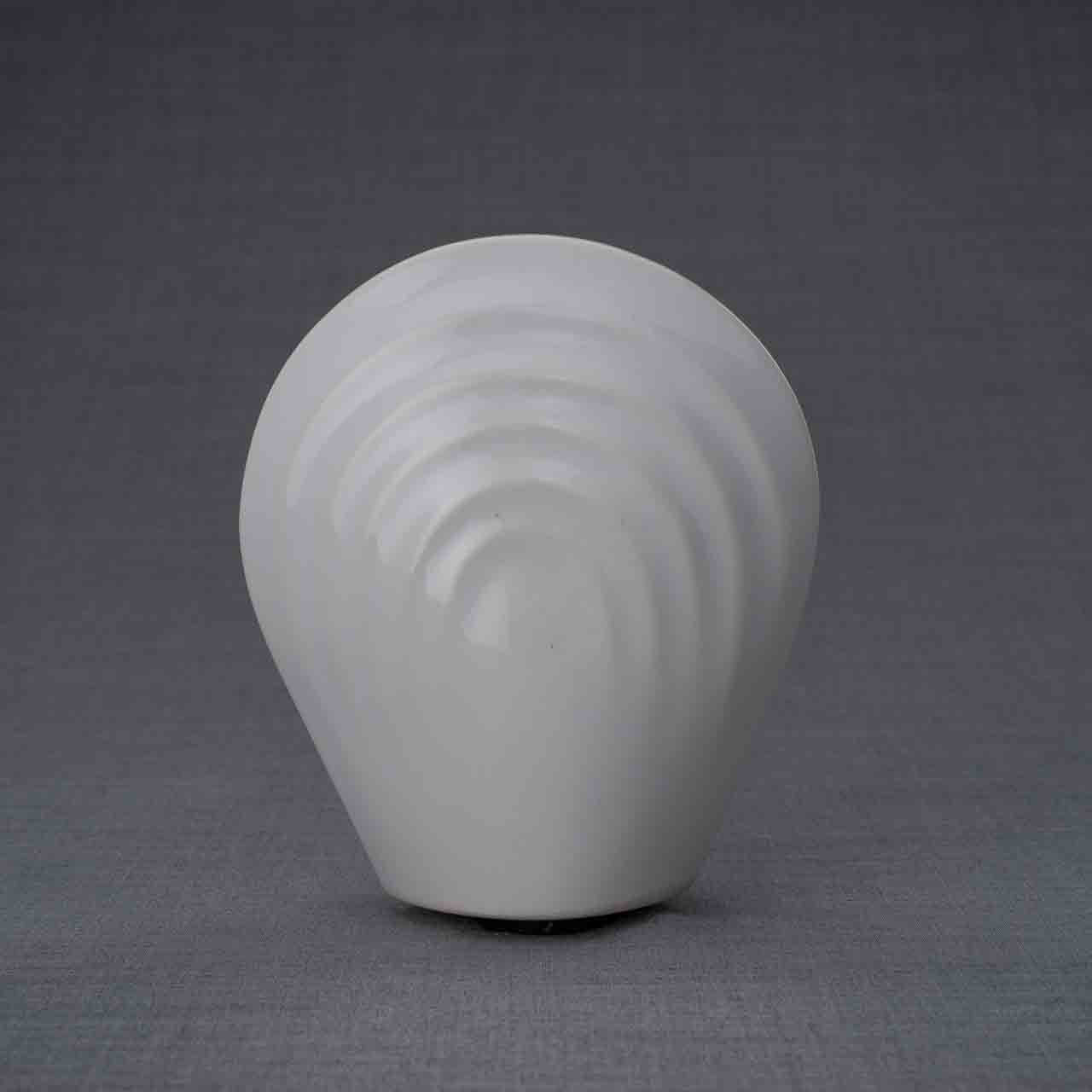 Guardian Angel Ashes Keepsake Urn in White Behind Dark Background