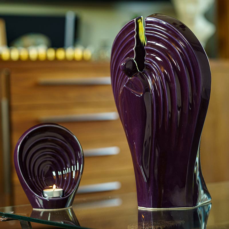 Guardian Angel Small Urn for Ashes with Adult Urn on Table violet