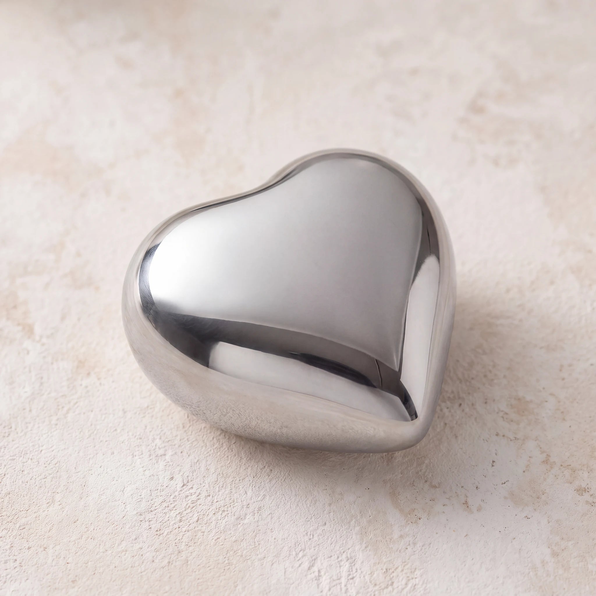 Heart-Keepsake-Urn-for-Ashes-in-Glossy-Silver-Metal-heart_plaster_above