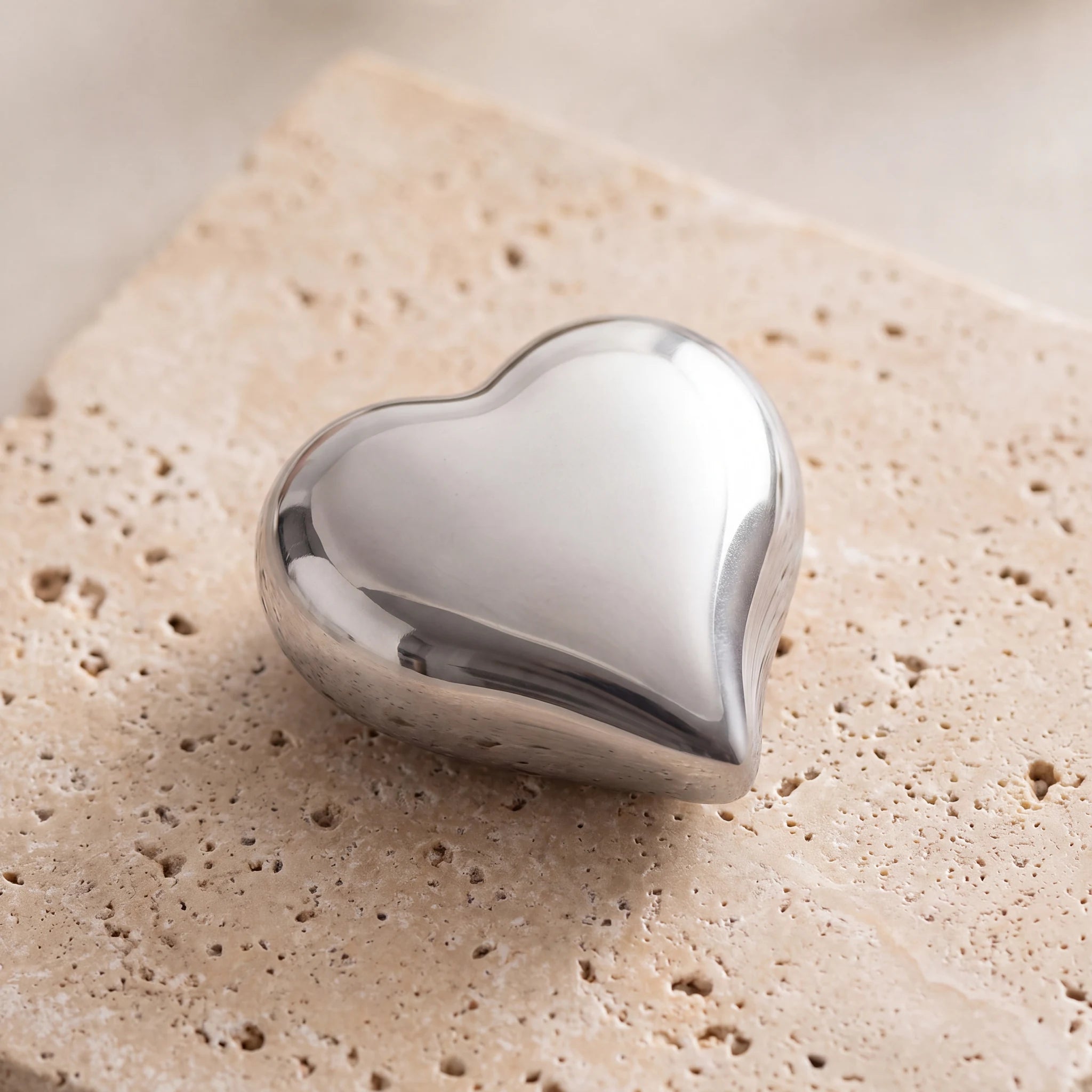 Heart-Keepsake-Urn-for-Ashes-in-Silver-On-Travertine