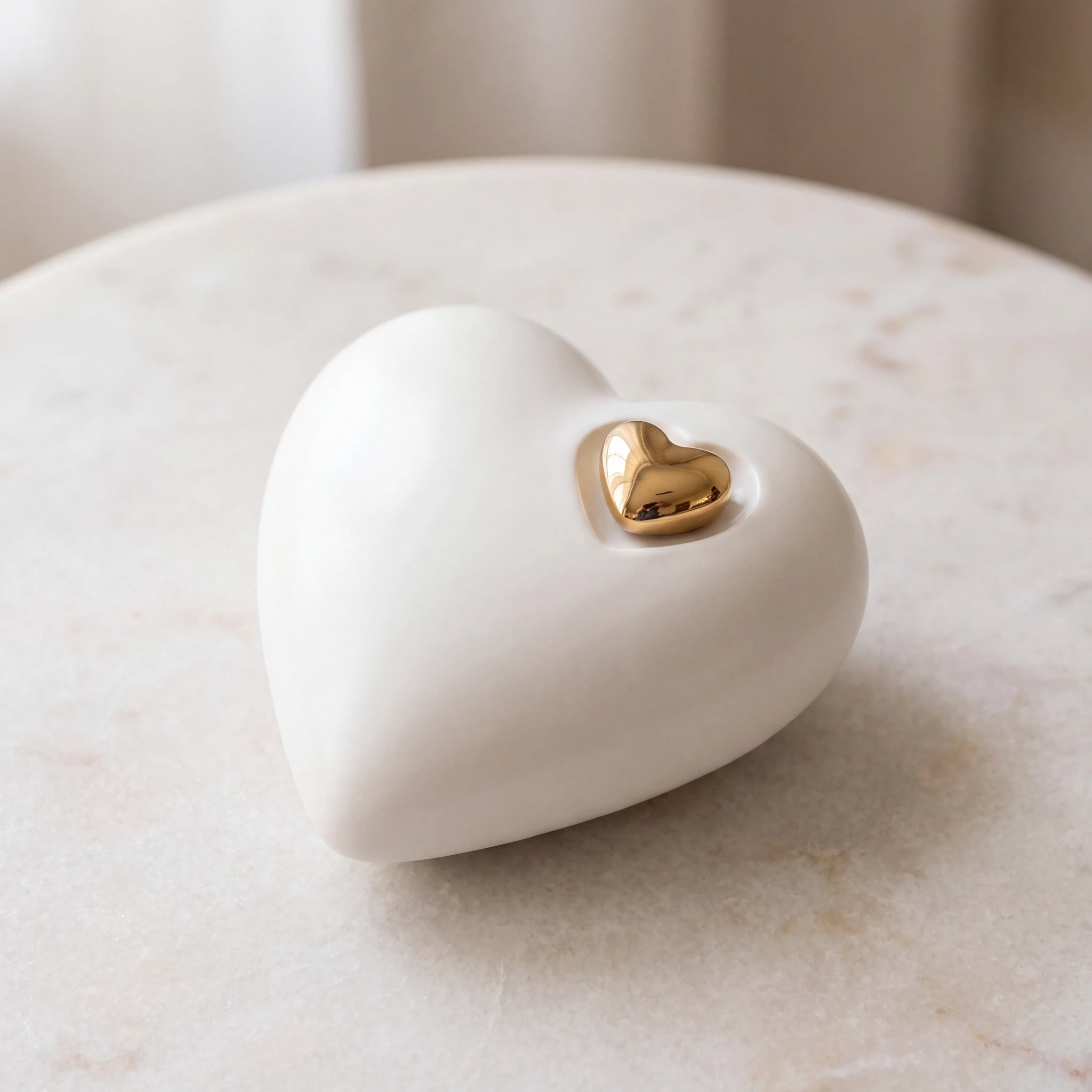 Heart-Medium-Urn-for-Ashes-in-White-and-Gold-On-Marble