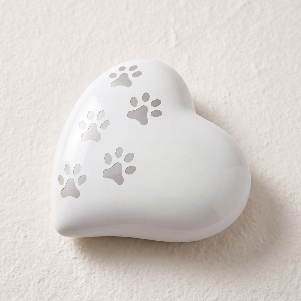 Heart-Pawprints-Pet-Urn-for-Ashes-in-White-Silver-Medium-heart_paper_above