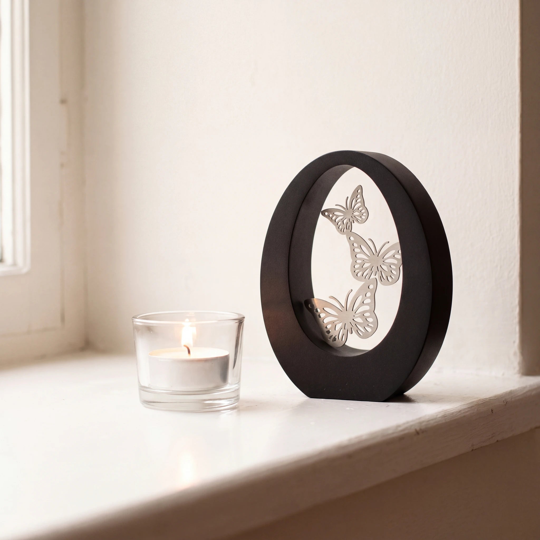 Hearts-Small-Urn-for-Ashes-in-Matte-Black-Stainless-Steel-keepsake_tealight_ledge