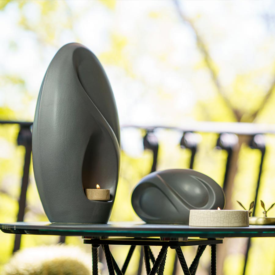 Infinity Cremation Urn for Ashes Matte Grey with Keepsake Outside on Table Side View
