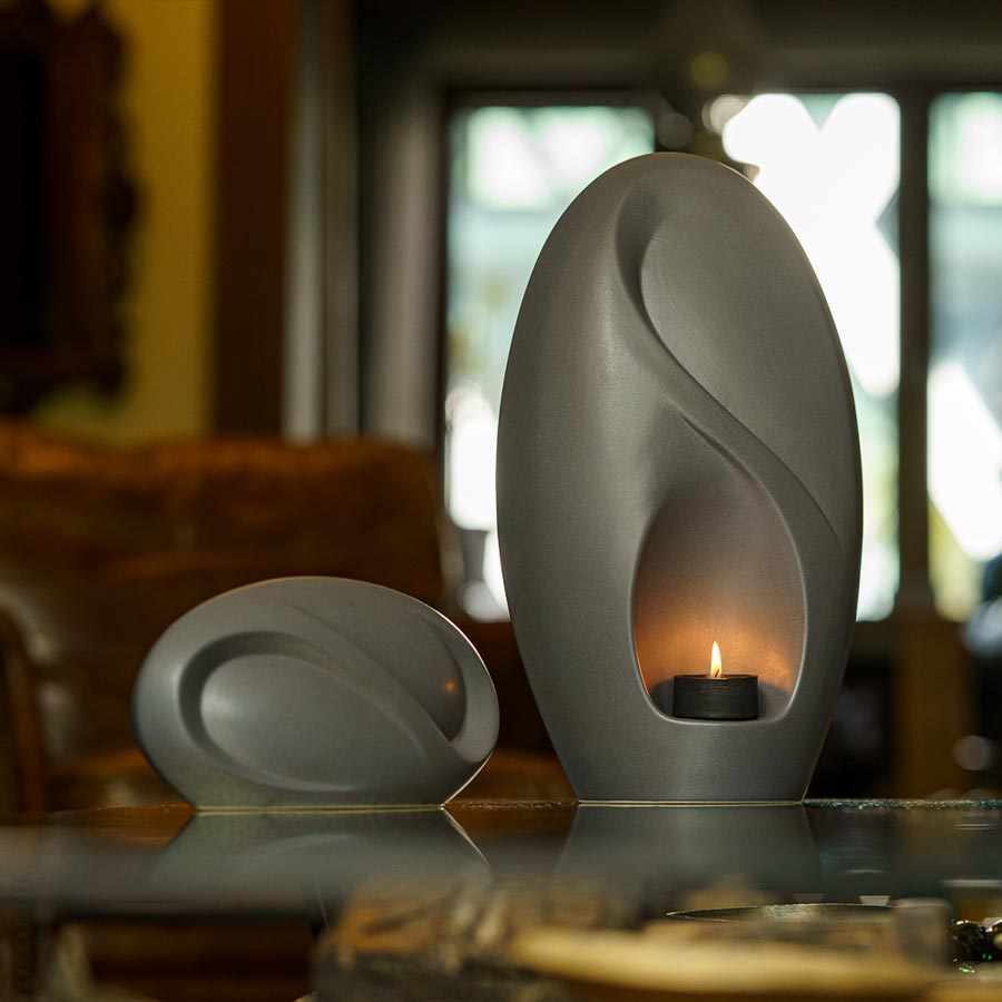 Infinity Cremation Urn for Ashes Matte Grey with Keepsake on Table