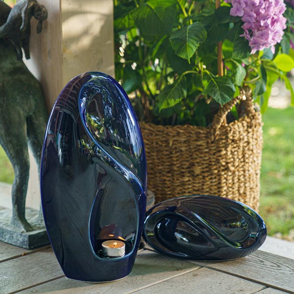 Infinity Cremation Urn for Ashes Metallic Blue on Steps by Plant