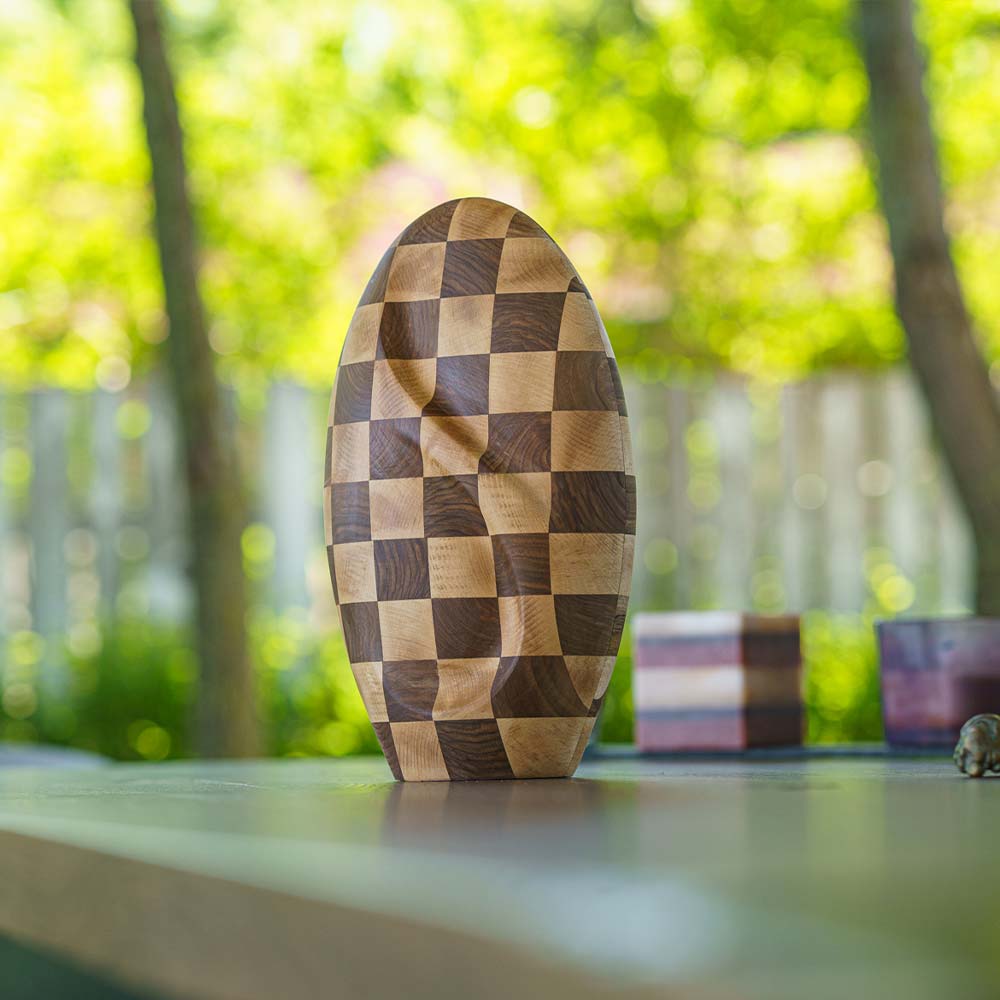 Infinity Wooden Adult Urn for Ashes Chequered Walnut and Beech Wood on Shelf Outside_eaa c c efafed
