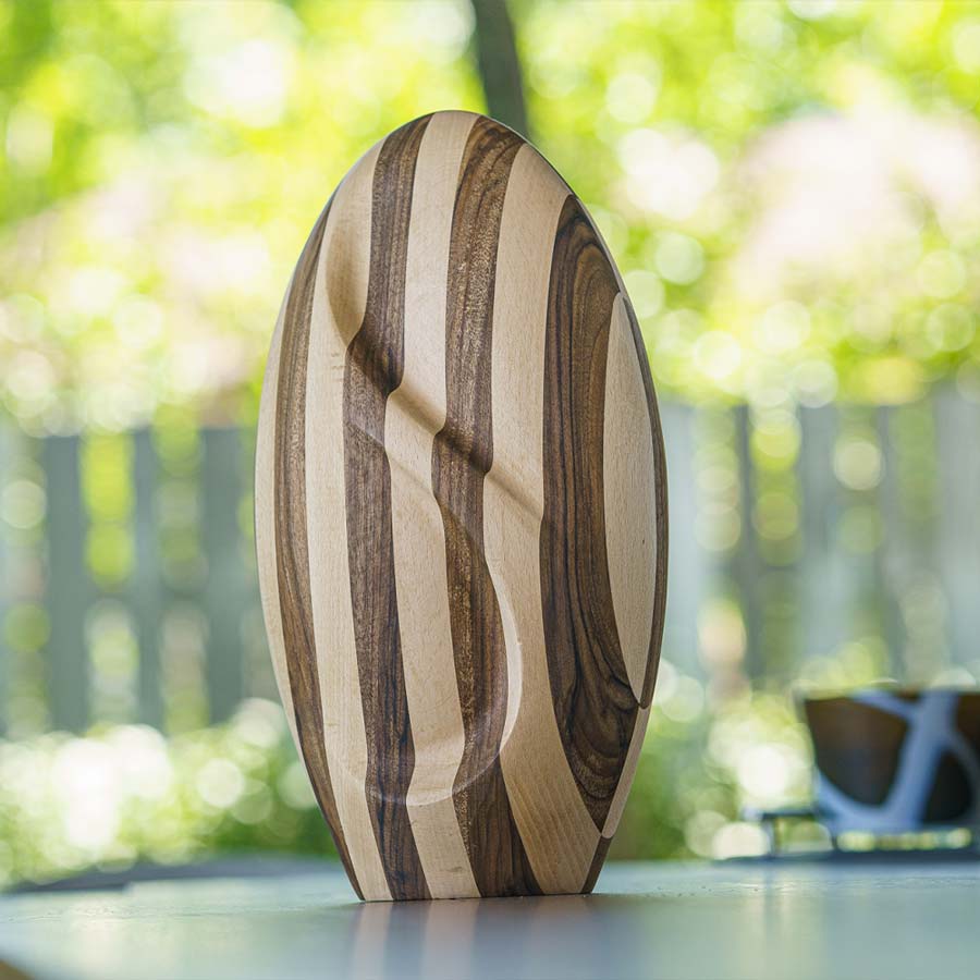 Infinity Wooden Adult Urn for Ashes Striped Walnut and Beech Wood on Table in Garden