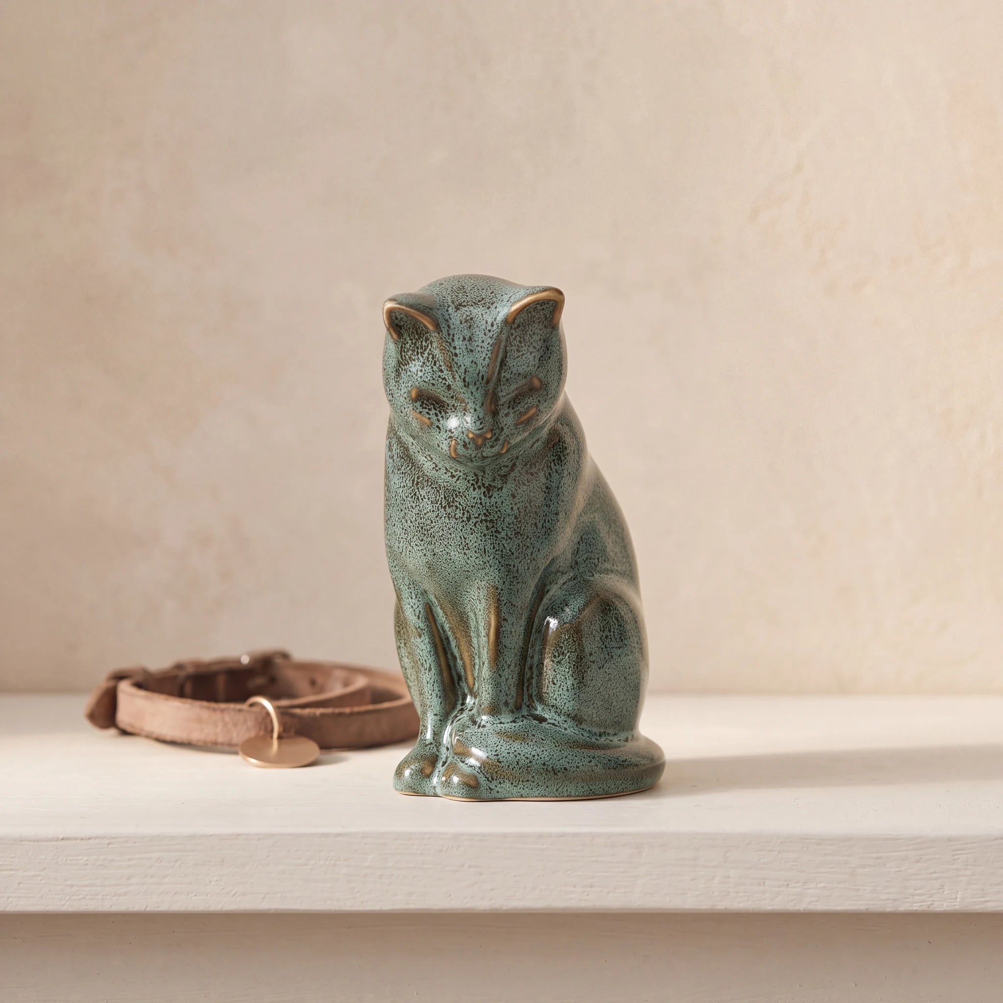 Kitten-Urn-for-Ashes-in-Oily-Green-pet_collar_ledge