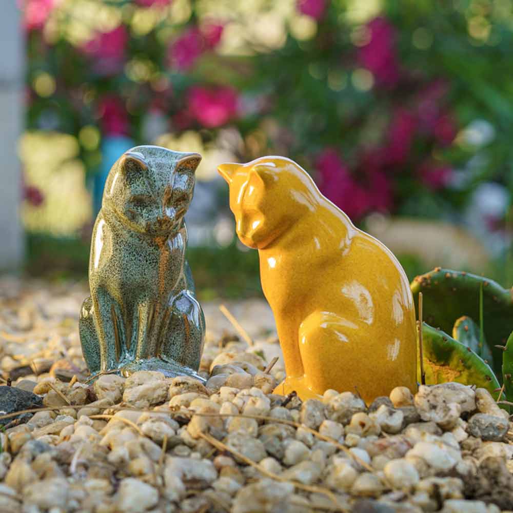 Kitten Urns For Ashes Outside Amber And Oily Green Close Up in Garden