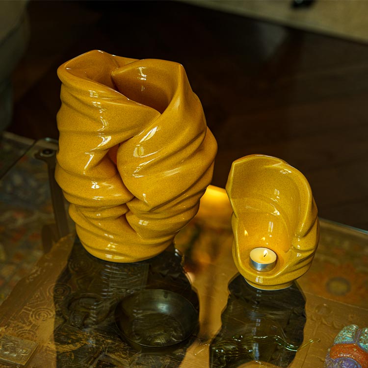 Light Ashes Keepsake Urn Amber with Adult Urn Top View on Table