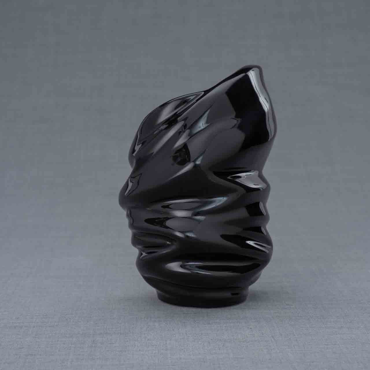 Light Ashes Keepsake Urn in Black Behind Grey Background