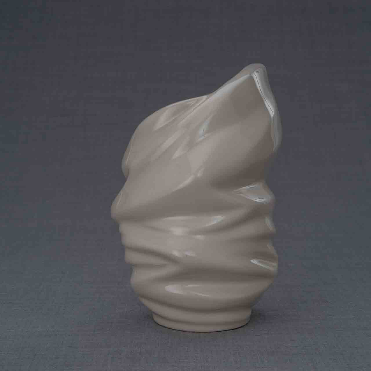 Light Ashes Keepsake Urn in Cream Behind Dark Background