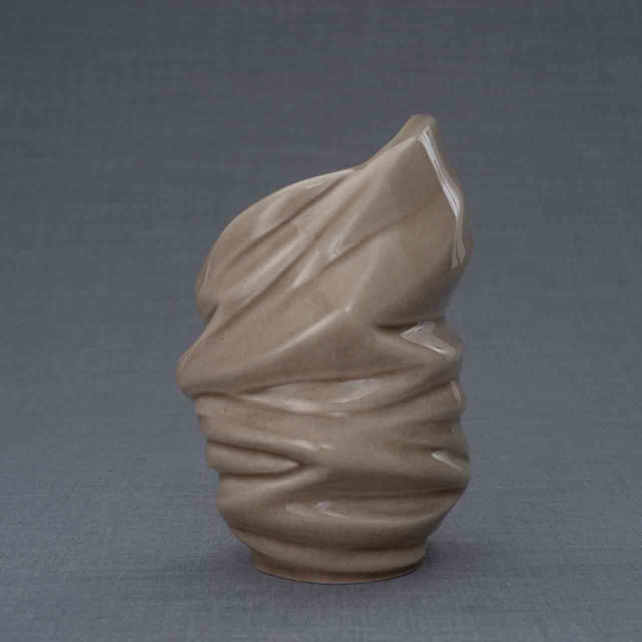 Light Ashes Keepsake Urn in Dark Beige Behind Grey Background