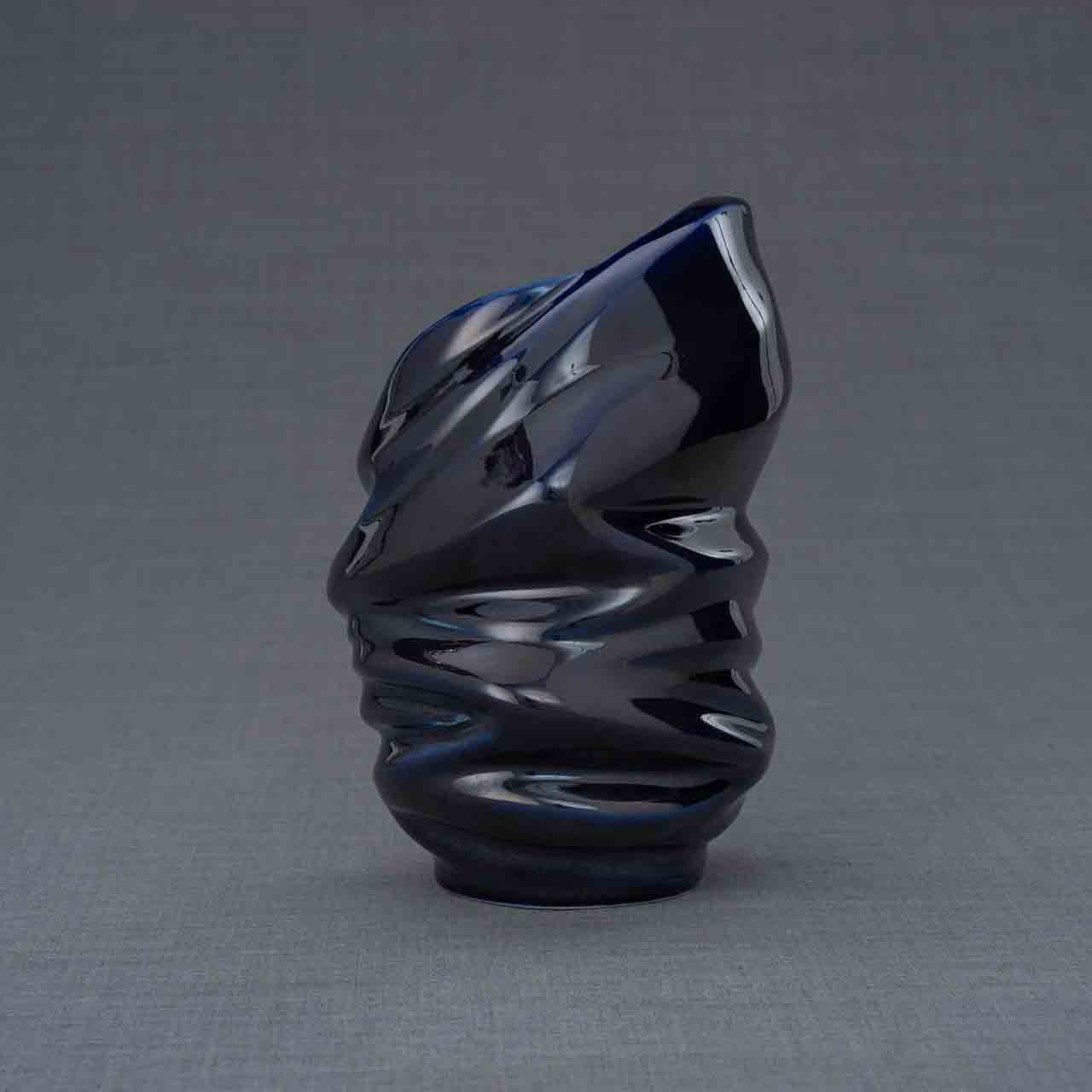 Light Ashes Keepsake Urn in Metallic Blue Behind Grey Background
