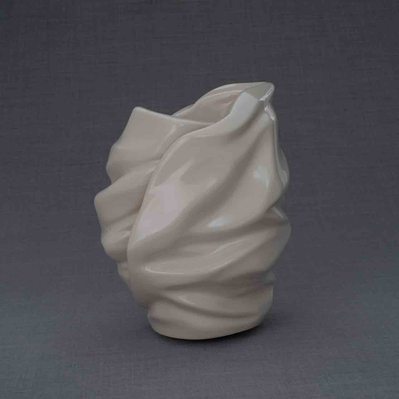 Light Cremation Urn for Ashes in Cream Behind Grey Background