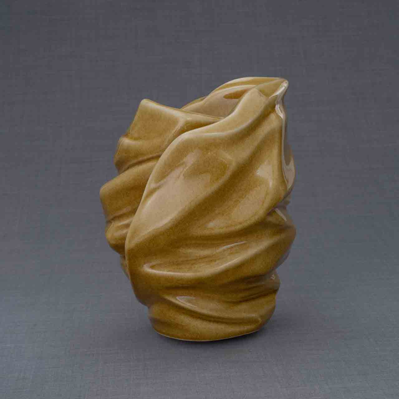 Light Cremation Urn for Ashes in Dark Sand Behind Grey Background