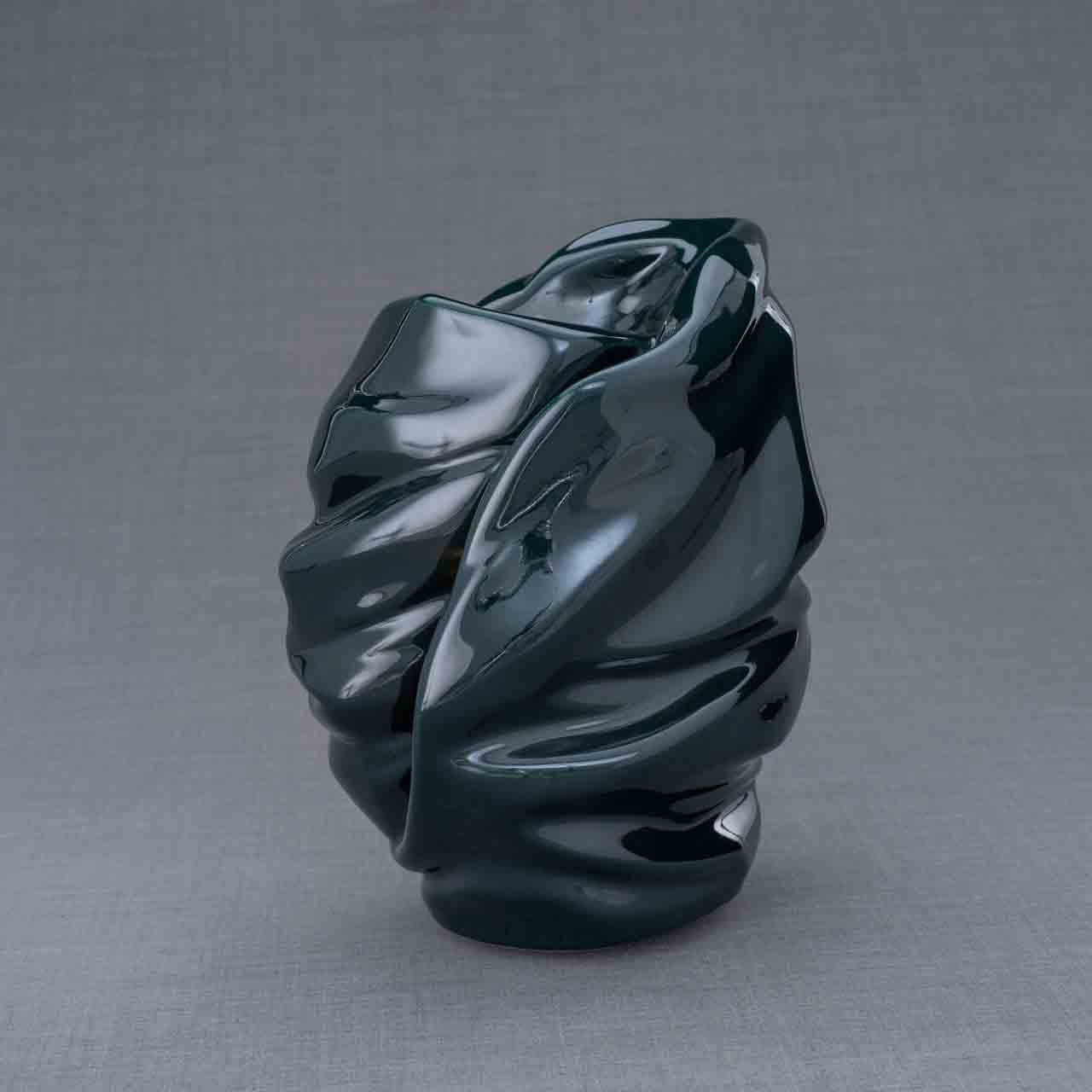 Light Cremation Urn for Ashes in Green Behind Dark Background