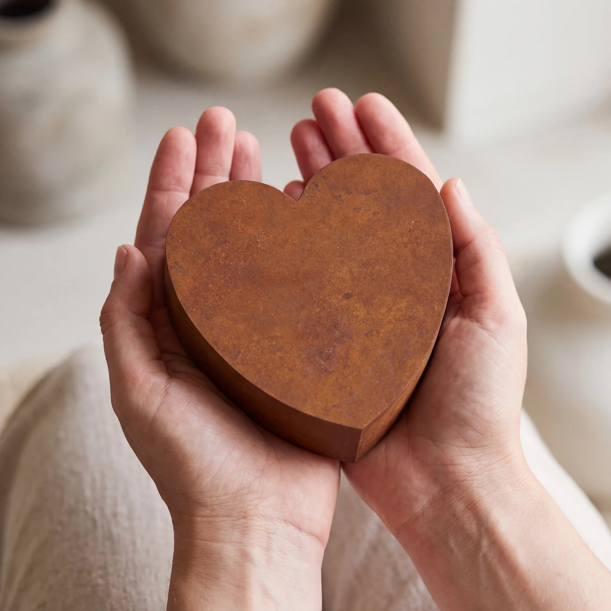 Love-Heart-Extra-Small-Urn-for-Ashes-in-Corten-Steel-Cupped-in-Hands