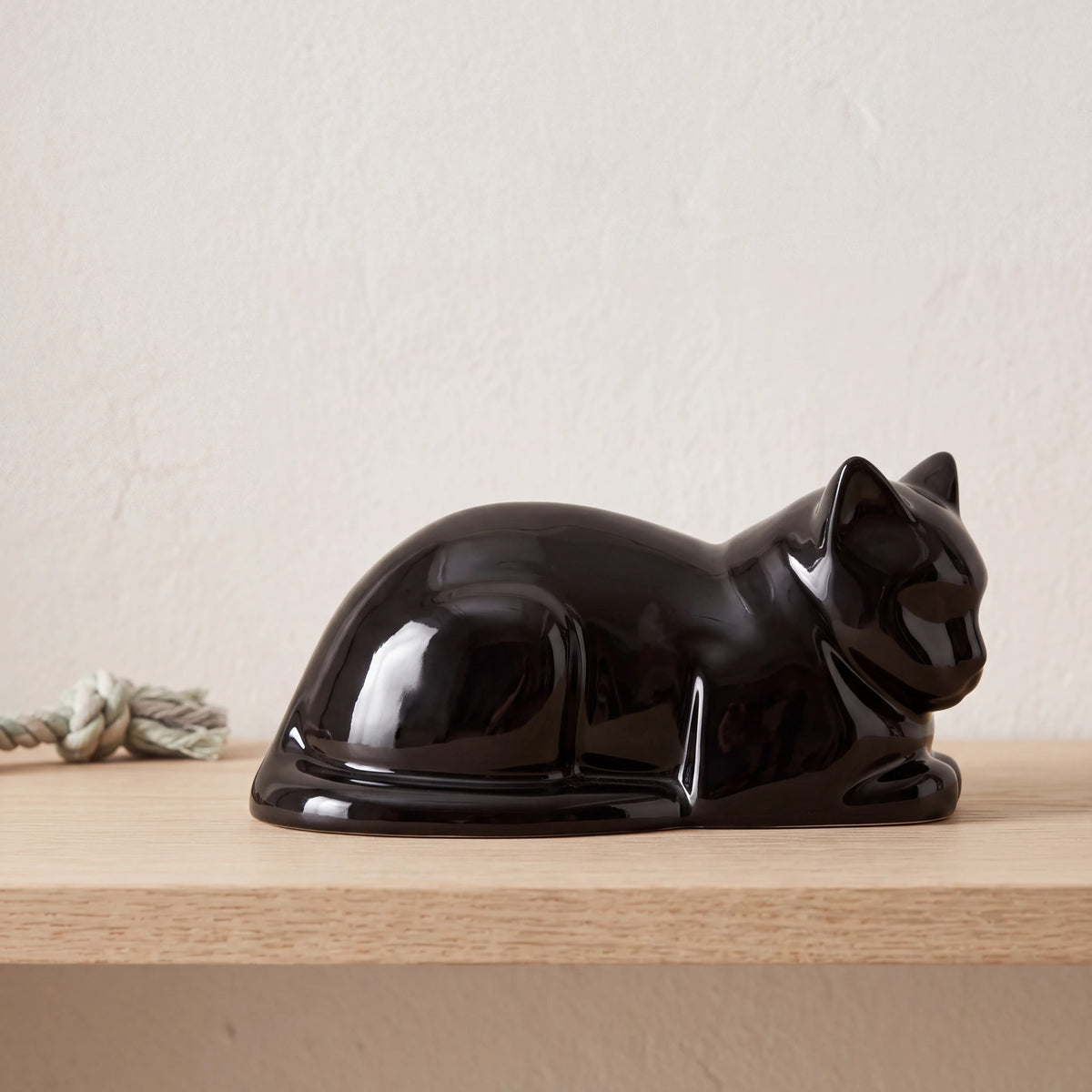 Lying-Cat-Urn-for-Ashes-in-Glossy-Black-pet_soft_toy_shelf