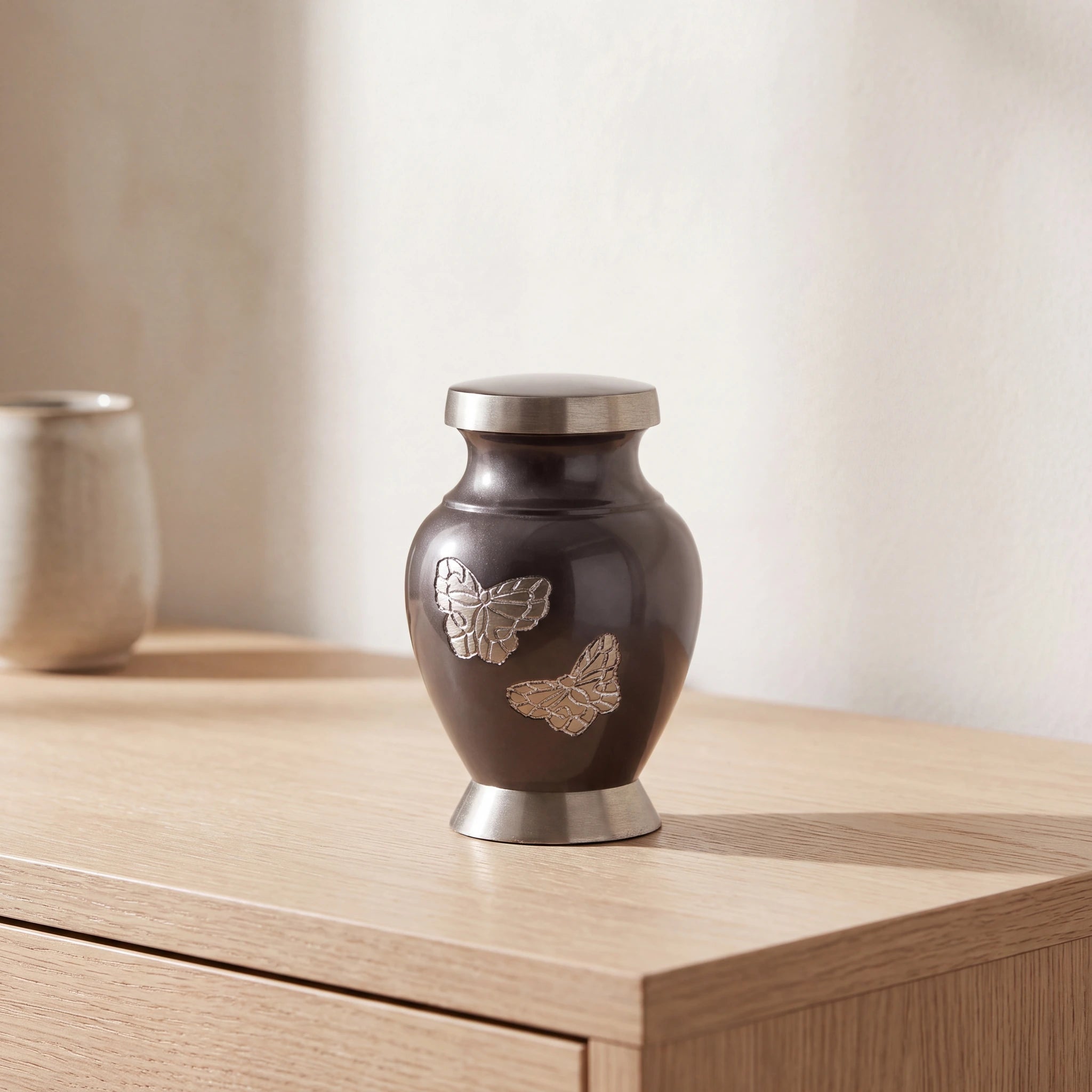 Metal-Butterfly-Keepsake-Urn-for-Ashes-in-Grey-with-Silver-Oak-Console