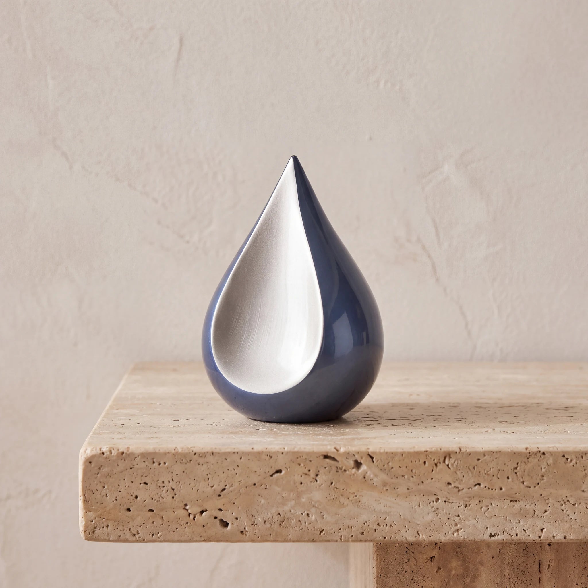 Odyssee-Metal-Teardrop-Keepsake-Urn-for-Ashes-in-Midnight-Blue-and-Silver-Travertine-Ledge