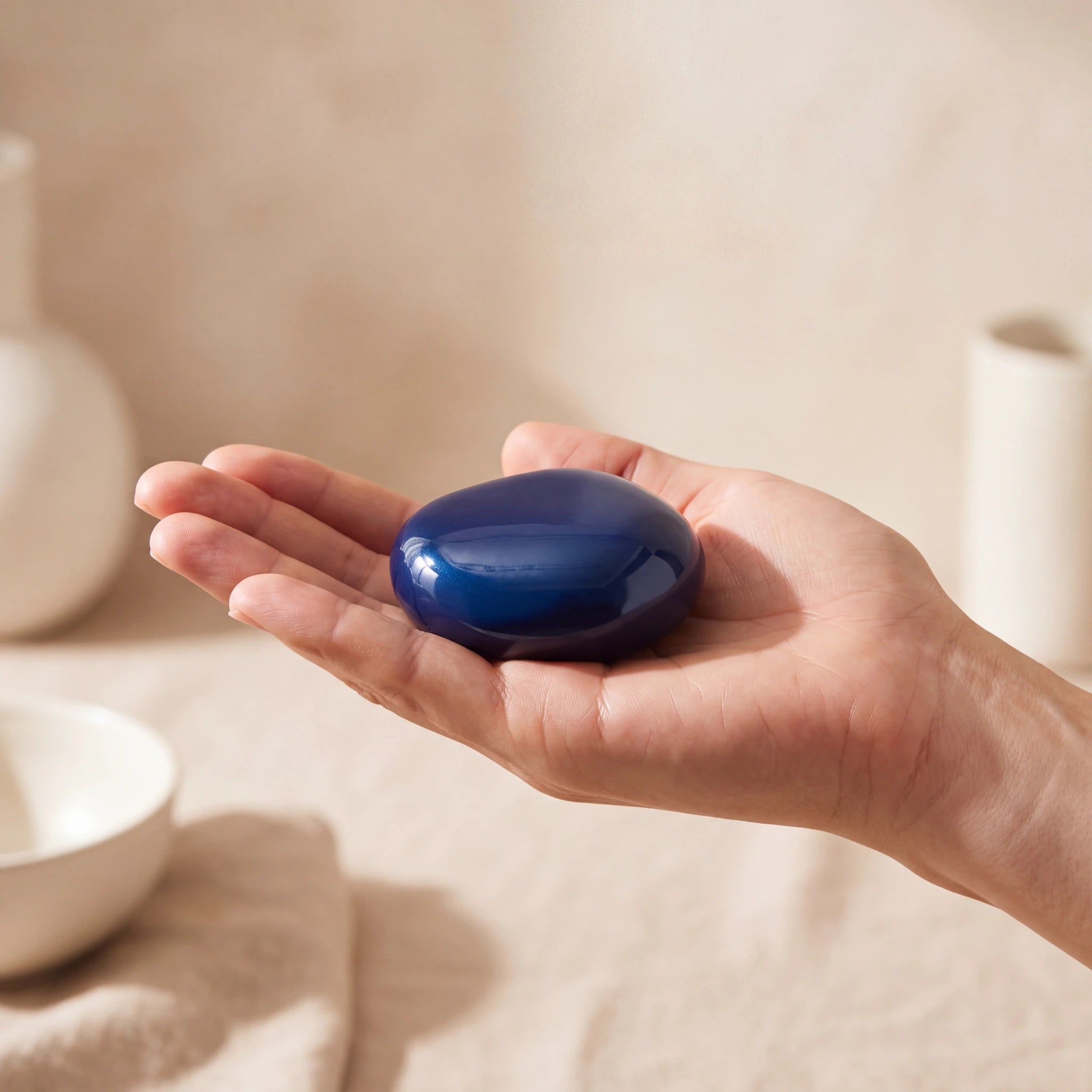 Palm-Stone-Small-Urn-for-Ashes-in-Metallic-Blue-In-the-Palm