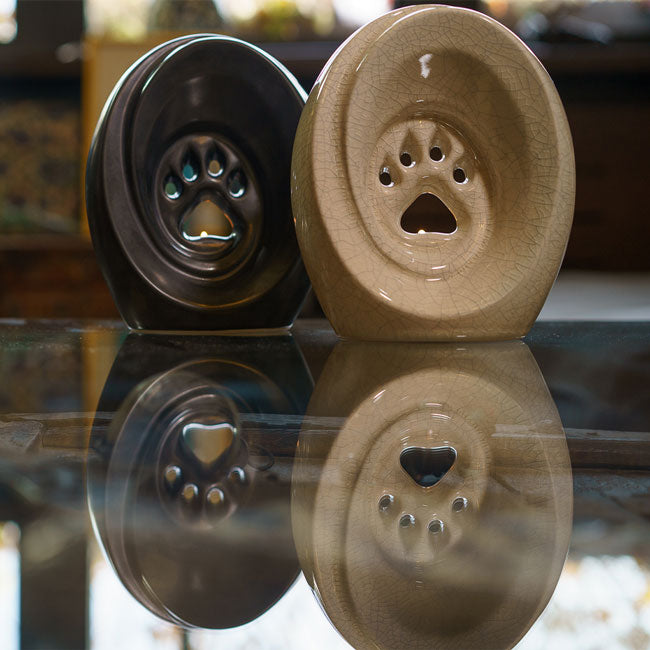 Paw Passage Cremation Urn For Ashes Matte Black Crackle Glaze On Glass Table