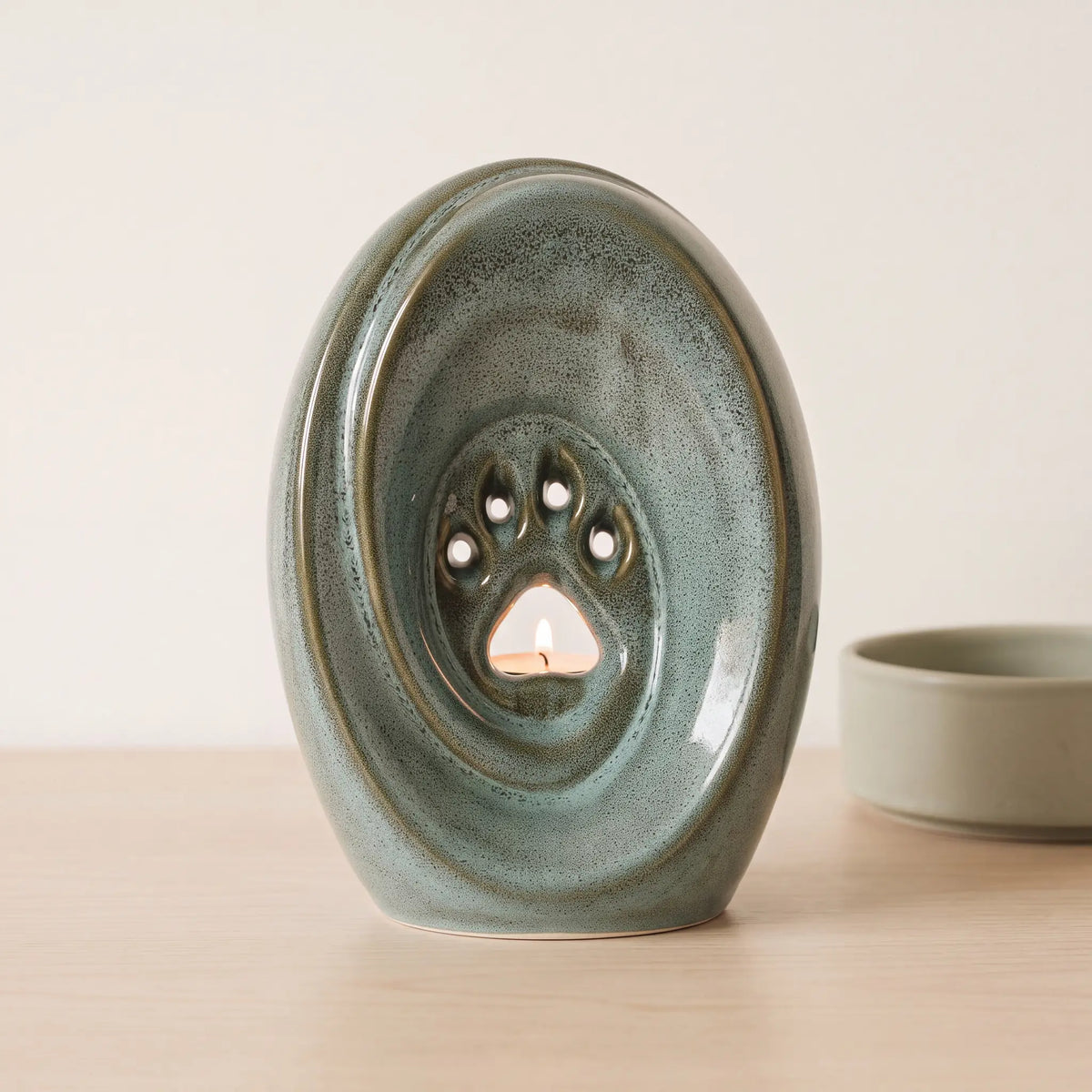 Paw-Pet-Urn-for-Ashes-in-Oily-Green-pet_bowl_ledge