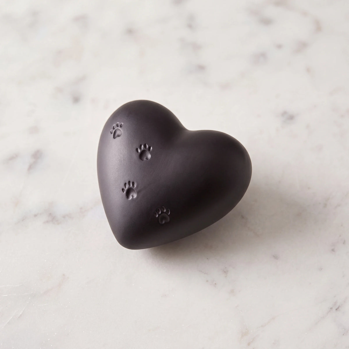 Paw-Print-Heart-Mini-Pet-Urn-for-Ashes-in-Black-On-Marble
