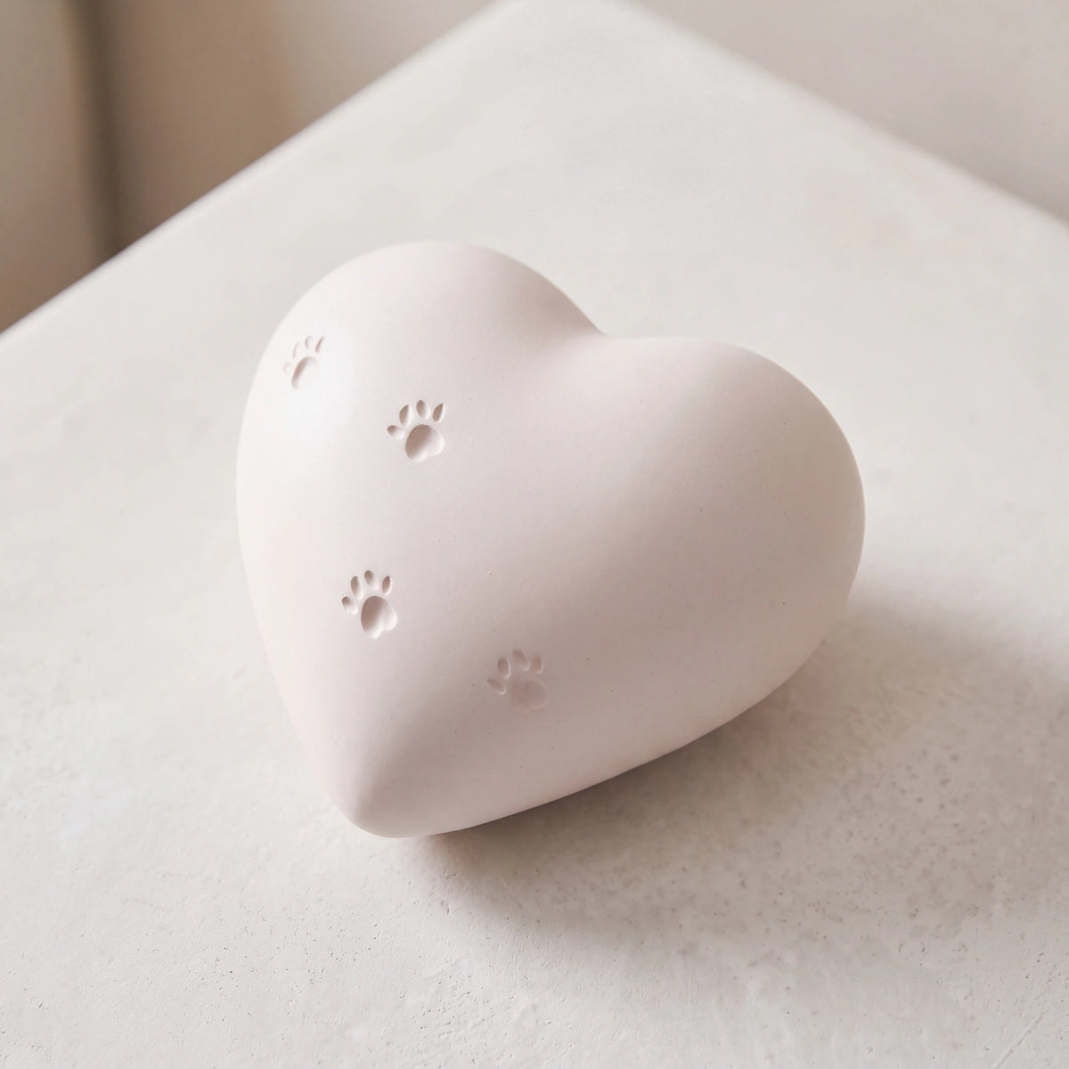 Paw-Print-Heart-Pet-Urn-for-Ashes-in-White-heart_plaster_above