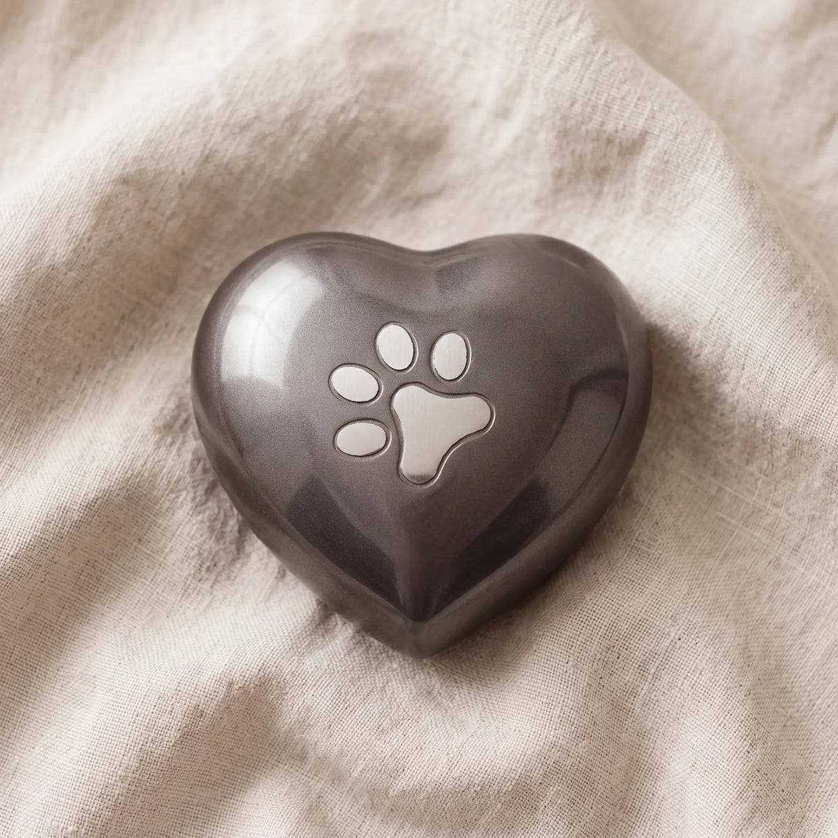 Pawprint-Heart-Pet-Urn-for-Ashes-in-Graphite-Silver-Medium-On-Linen