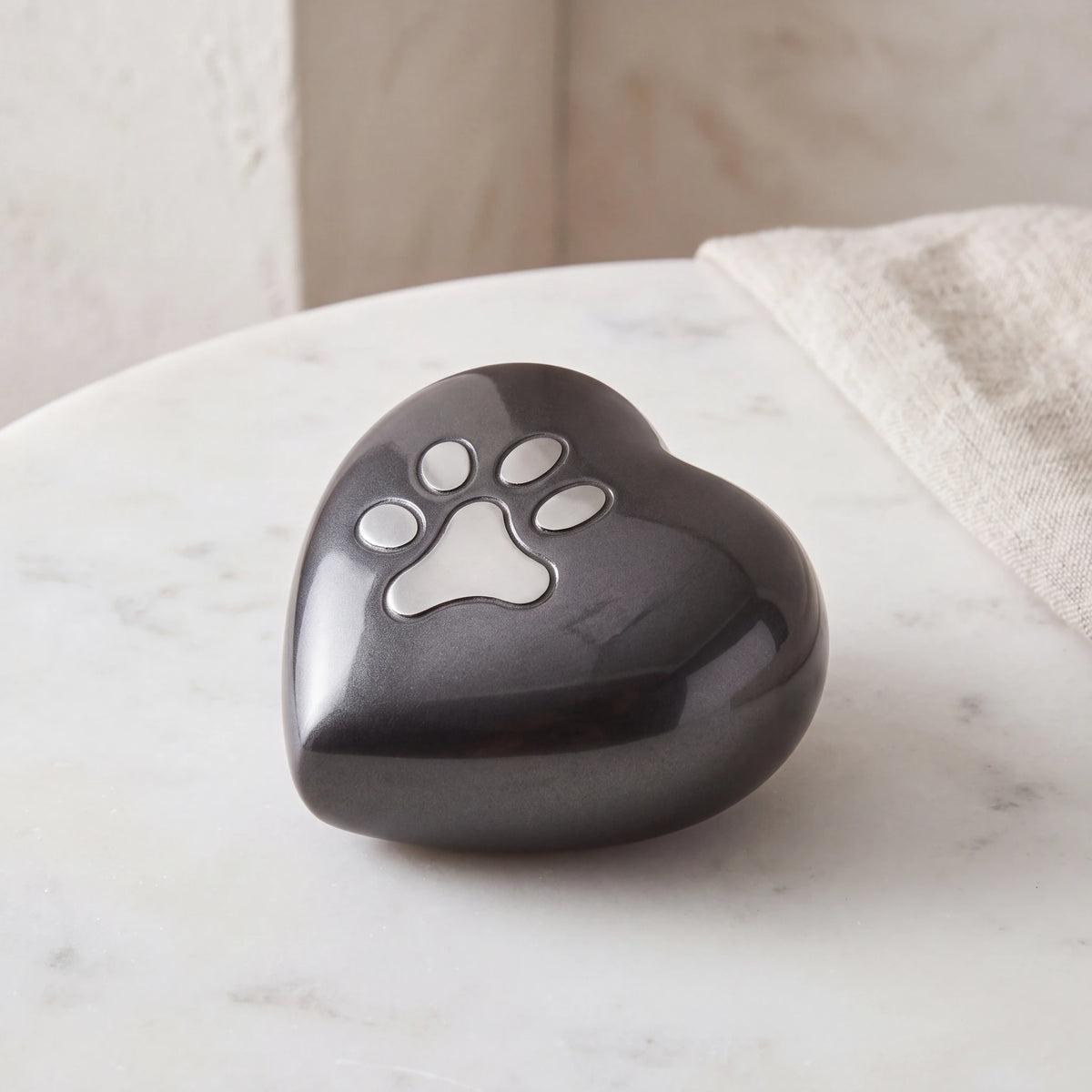 Pawprint-Heart-Pet-Urn-for-Ashes-in-Graphite-Silver-Small-On-Marble